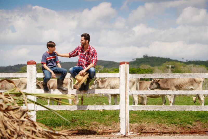 Family outside of cow pen cattle pasture